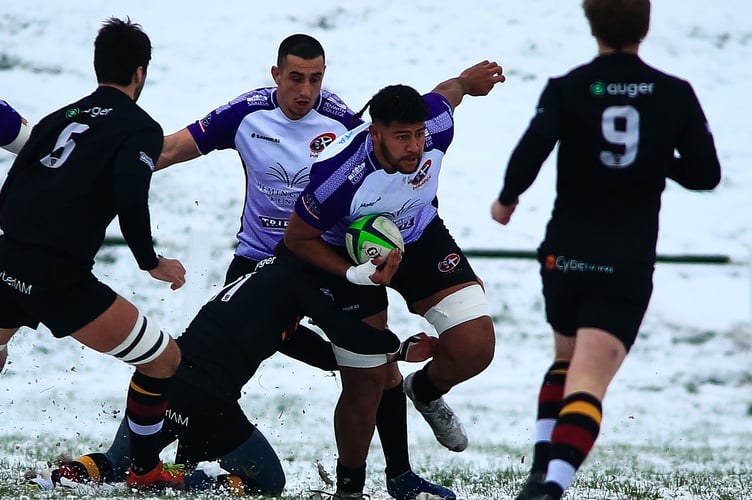 Cornish Pirates' Rus Tuima holds off a Caldy tackle
