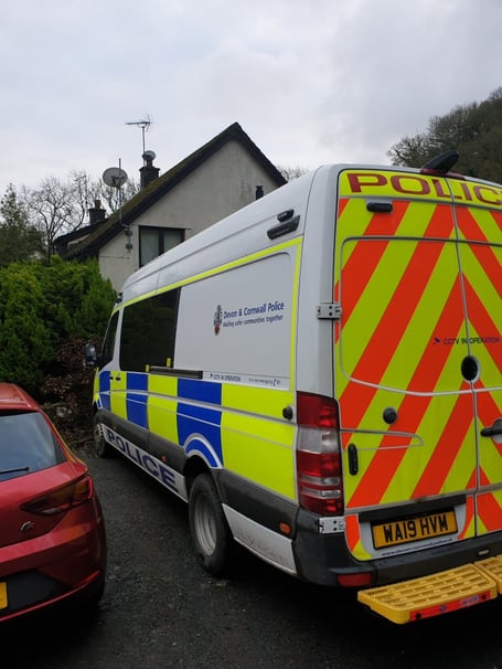 A Police van attending the property in Sticklepath