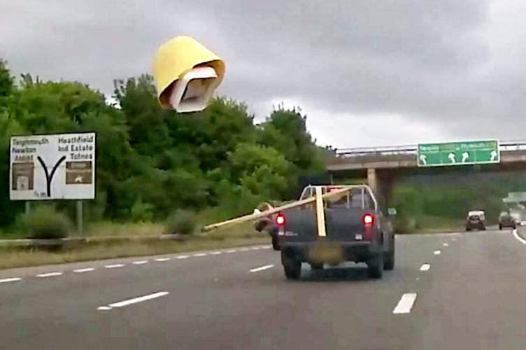 A bucket and planks fall off the back of a truck on the A38