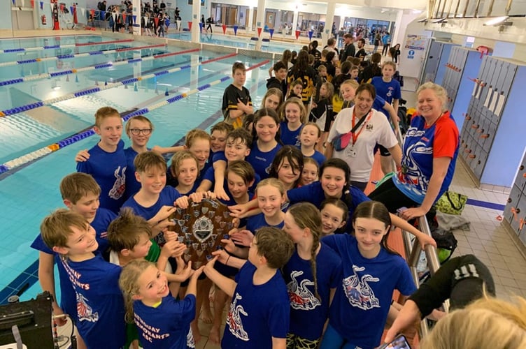 IT’S OURS: plenty of the Cormorants team trying to get their hands on the County Interclub Shield they won.