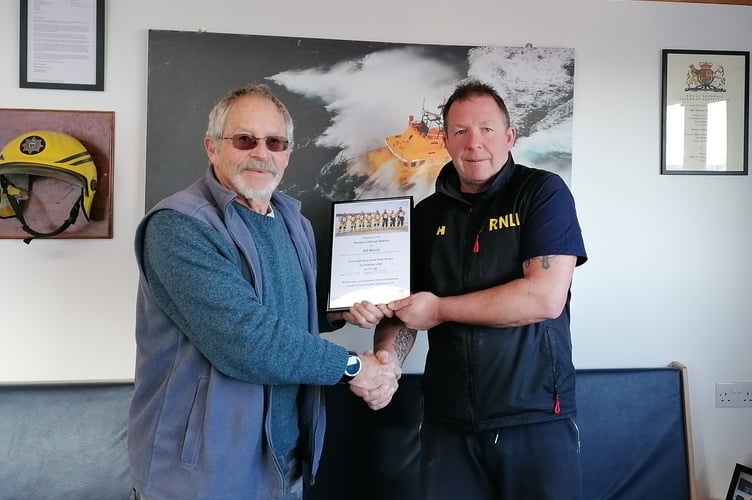 Kif Wood receiving his thank you certificate from Penlee RLNI