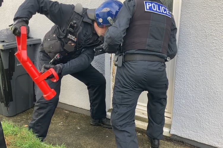 Police target a property in St Austell