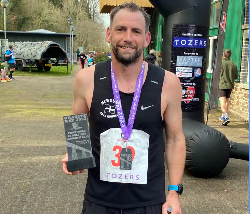 Darren Roose with his medal and trophy