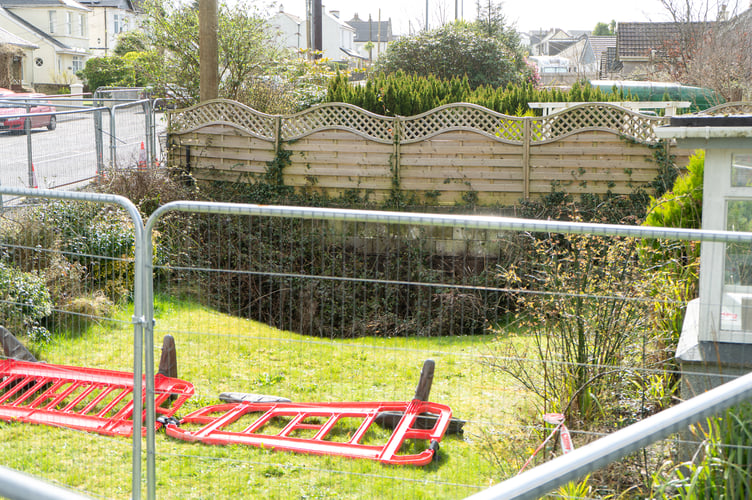 101 S Downs, Redruth Photographed on the 24/03/2023 after a part of its garden falls into disused mine workings.  See SWNS story SWLNmines. Residents of two homes were forced to flee after their gardens fell - into a disused MINE. The pair of bungalows were left uninhabitable when a massive 2m (6.4ft) hole opened up in the gardens. The homes are in Redruth in Cornwall - an area where there are many disused mines mainly from the tin and copper mining industry. Properties on the street were said to have lost electricity following the mine collapse on Sunday. 