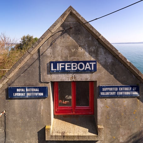 Penlee Lifeboat House and Slipway, Penlee Point, Mousehole, Cornwall.Detail view of  west elevation to road showing  upper window and signage. View from west. Built 1911-13 to a design by W. T. Douglass, engineer and architect to the Royal National Lifeboat Institution.