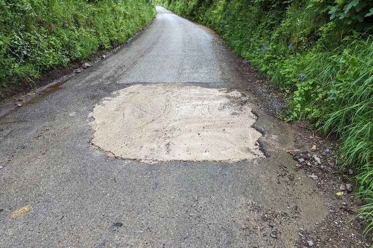 A mystery 'volunteer' filled the Lostwithiel pothole with concrete