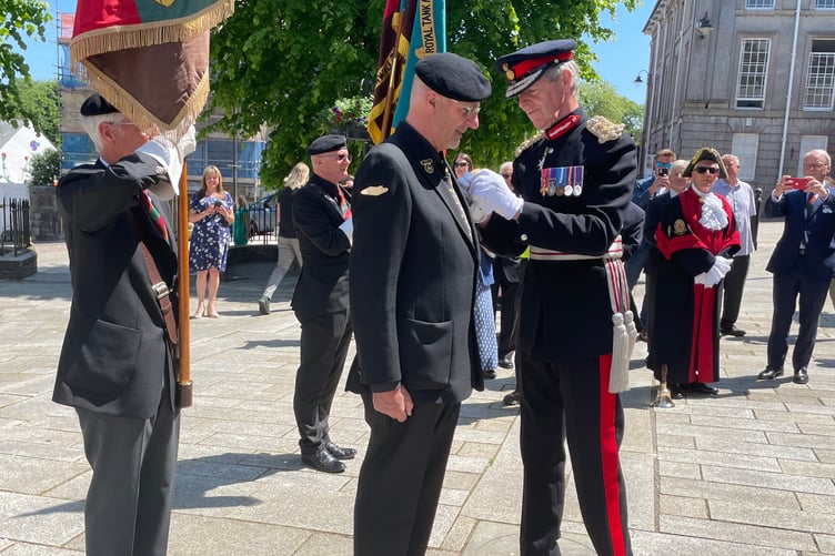 Lord Lieutenant Edward Bolitho investing Chris Lock with the British Empire Medal in a ceremony held on Bodmin Mount Folly
