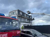 Residential roads are closed as firefighters tackle roof blaze