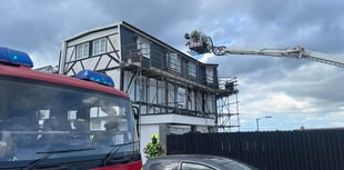 Residential roads are closed as firefighters tackle roof blaze
