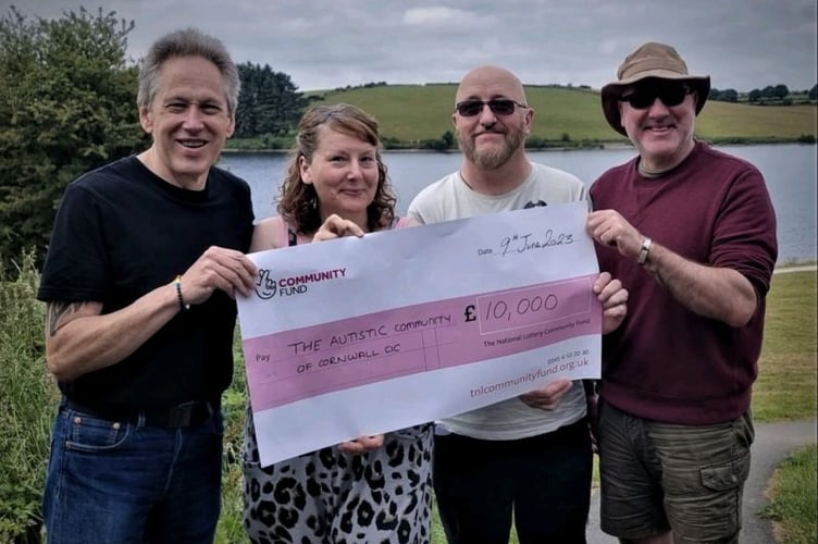 The Autistic Community of Cornwall receiving a cheque for £10,000 from the National Lottery