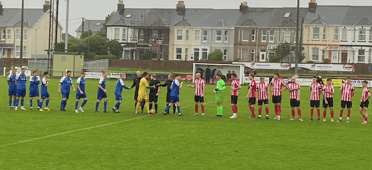 Saltash and Helston players shake hands before the game