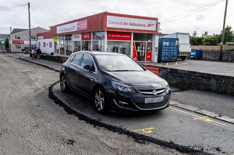 Highways staff worked around a car left on Clifden Road in St Austell on Monday
