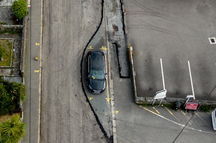 Highways staff worked around a car left on Clifden Road in St Austell on Monday