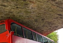 Double-decker bus hits railway bridge