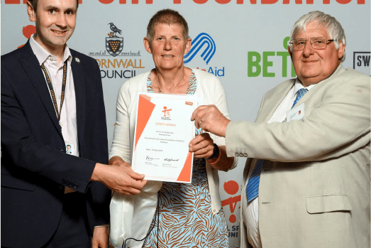 Theresa Frost receiving her GLL Sports Foundation award from councillors Nick Craker (left) and Julian Smith