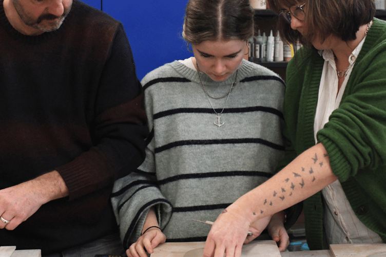 The community gets to work at the first mosaic workshop led by Alec Rice