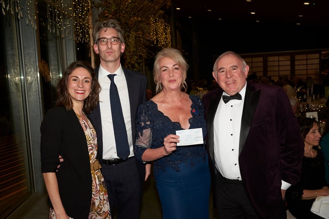 Aude Langsford, Simon Langsford, Sue Wilkins and Chris Kallis presenting a cheque at the ball 
(Picture: Charlie Hopkinson)