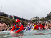 Brave people take the plunge for New Year's Day charity dip in Newquay