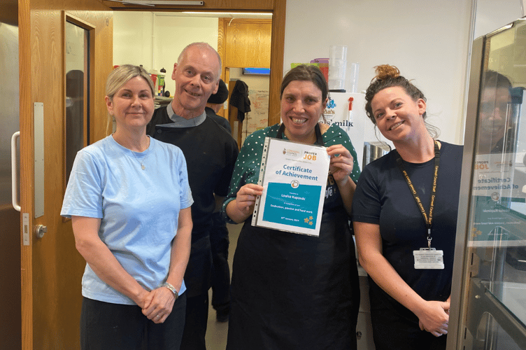 Louise Kupinski receives a certificate of achievement after a successful work placement at the County Hall Cafe