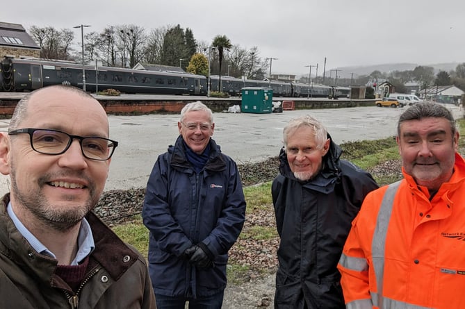 Colin Martin pictured at Lostwithiel Railway Station with representatives of the town council and Network Rail