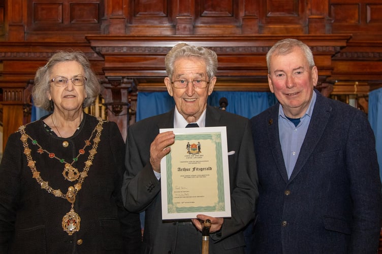 Arthur Fitzgerald receives his award from Malcolm Bell and Cllr Carol Swain