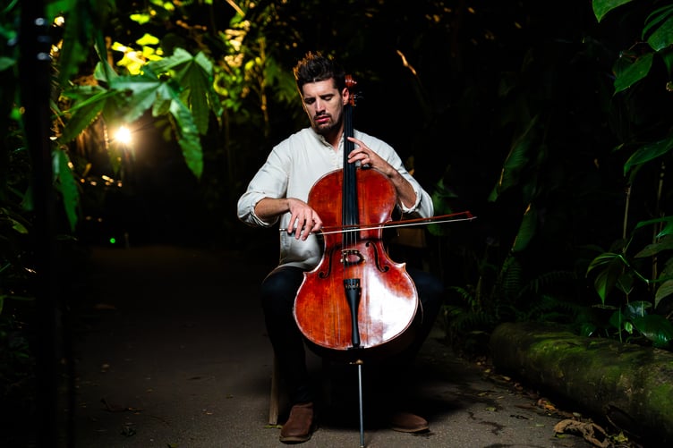 Luka Sulic playing the cello inside the rainforest biome