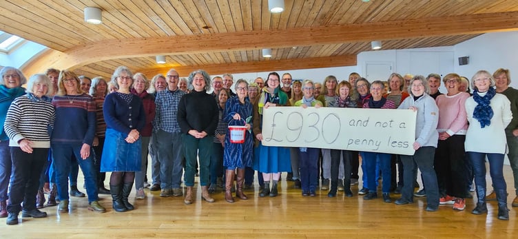 The Suitcase Singers present a cheque for £930 to ShelterBox