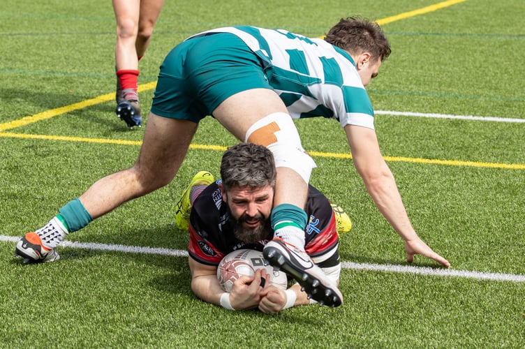 Camborne hooker Ben Priddey grounds one of his five tries in the big win at Exeter University