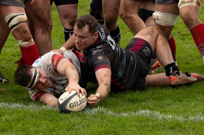Camborne's Adam Hughes dots down the fifth home try in Saturday's clash with Newport