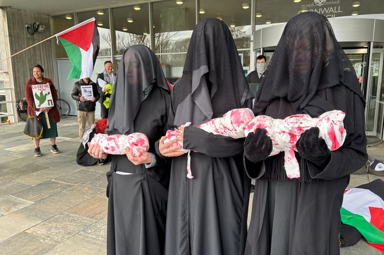 Protestors pose as mourning mothers from Palestine outside Lys Kernow in February 2024
