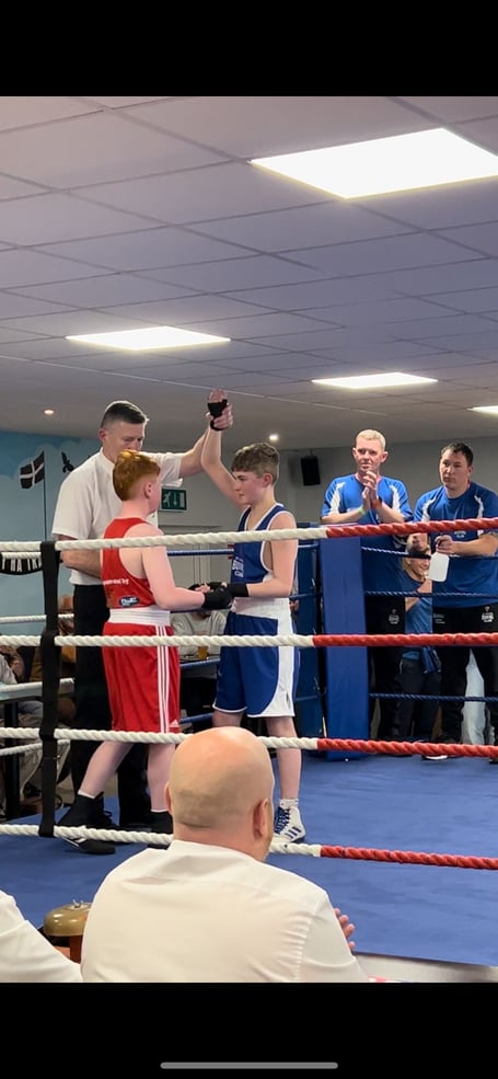 Riley (blue) celebrates his success while consoling his opponent.