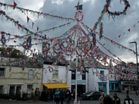 Local residents watch Obby Oss parade through pub