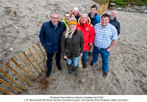 New sand dune structure created to protect village from flooding