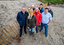 New sand dune structure created to protect village from flooding