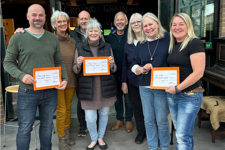 The Mevagissey Entertainers present cheques to three local good causes.