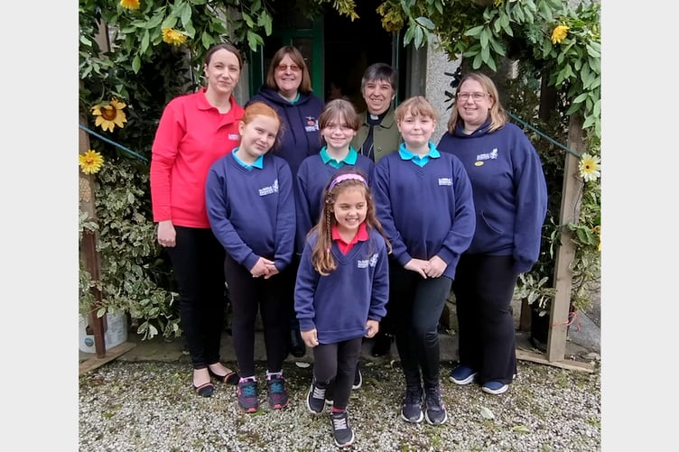 Some members of the 1st Leek Seed Girls Brigade meet national chaplain, the Rev Gill Newton, at Leek Seed’s celebration flower festival.