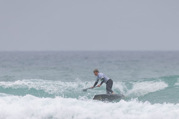 Home favourite Christina Doviak, who won the Women's SUP  division, battles the waves.