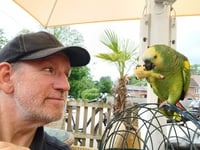 Plucky parrot rides with family peloton for charity