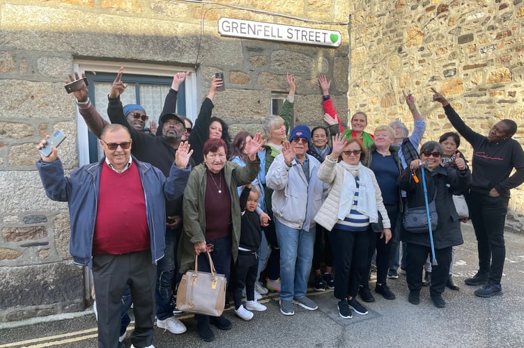 2023 500th guest - at Solidarity Street sign in Mousehole - photo Cornwall Hugs.jpg