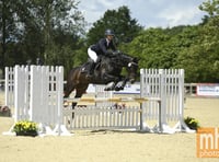 Students jumping for joy after national equestrian success