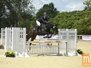 Students jumping for joy after national equestrian success