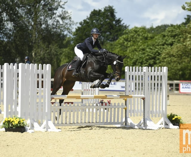Students jumping for joy after national equestrian success