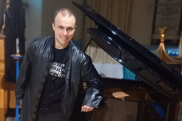 Rhys Wynne-Jones stands alongside piano at Penzance NightChurch