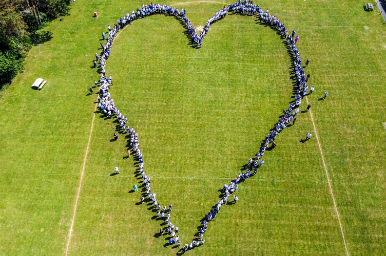 Roseland Academy students and staff created a heart to celebrate an Outstanding Ofsted report