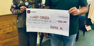 Brownie Pippa gives cheque to Sunny Corner