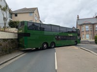 Traffic disruption ensues after bus hits wall 