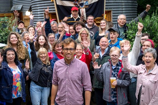 Noah Law, the new Labour MP for St Austell and Newquay, takes a break to celebrate with supporters.