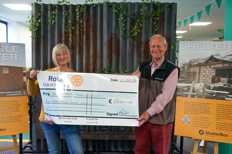 Elke Deeley and club member David Foster with a giant cheque for ShelterBox.