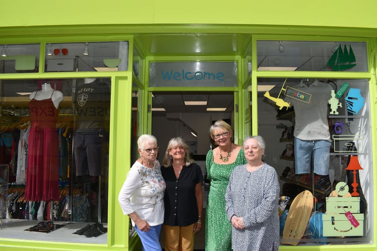 The shop team outside the front door 