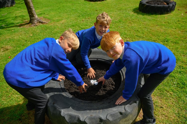 St Stephen Churchtown Academy pupils planting wild flowers in recycled tyres